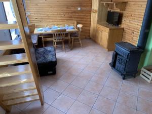 a dining room with a table and a stove at Apartments Nune in Zreče