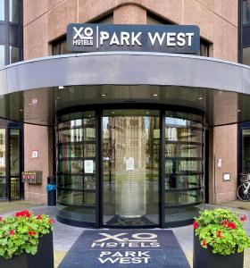 a park west entrance to a library with two plants at XO Hotels Park West in Amsterdam
