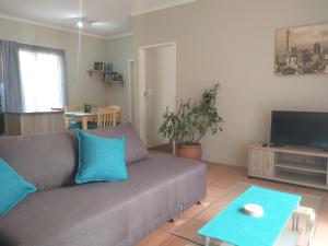 a living room with a couch and a tv at Burban Bliss in Johannesburg