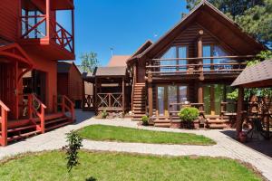 a log house with a porch and a patio at Sosnovy Dvor Guest House in Sevastopol