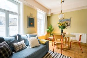 a living room with a blue couch and a table at Smartflats - Central Ghent in Ghent