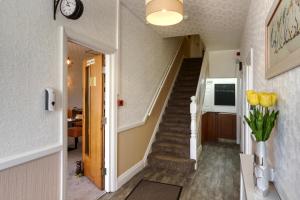 a staircase in a house with yellow tulips at Palm Court in Skegness
