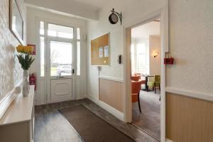 a hallway with a door leading to a dining room at Palm Court in Skegness