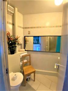 a bathroom with a toilet and a chair in it at Splendid 1 Bedroom Flat + Terrace (Kentish Town) in London