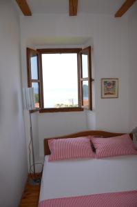 sypialnia z 2 łóżkami i oknem w obiekcie Apartments Brautović w Dubrowniku