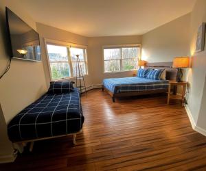 a living room with two beds and a couch at E7 Sunny Bretton Woods private home next to the slopes of Bretton Woods Hot Tub, Wifi in Carroll +50 photos