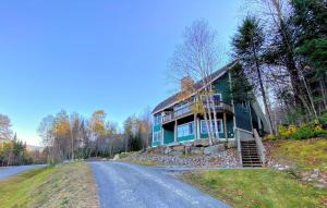a house on the side of a road at E7 Sunny Bretton Woods private home next to the slopes of Bretton Woods Hot Tub, Wifi in Carroll
