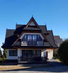 a large house with a gambrel roof at Domki U Hani in Murzasichle