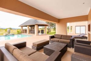 a living room with a pool and a gazebo at Waterberg House at Zebula - 8 adults and 4 kids in Mabula