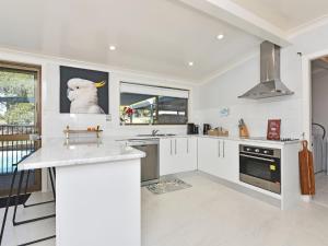 a kitchen with white cabinets and an animal on the wall at Blaxlands Homestead - Nothing is closer opposite Hope Estate with Wifi and Pool plus Fireplace in Pokolbin