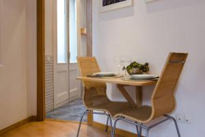 a dining room table with two chairs and a table and chairsuggest at Ripoll Apartments in Barcelona