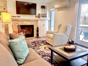 a living room with two couches and a fireplace at R5 Completely renovated Bretton Woods condo AC unbeatable SKI-IN SKI-OUT location Fast wifi in Carroll