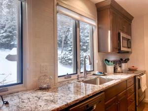 a kitchen with a sink and two windows at R5 Completely renovated Bretton Woods condo AC unbeatable SKI-IN SKI-OUT location Fast wifi in Carroll