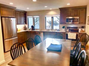 a kitchen with a large wooden table and chairs at R5 Completely renovated Bretton Woods condo AC unbeatable SKI-IN SKI-OUT location Fast wifi in Carroll
