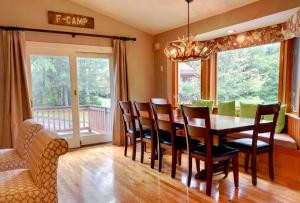 a dining room with a table and chairs at O7 Slopeside Bretton Woods Resort cottage with upscale stylings cozy decor tons of space in Carroll