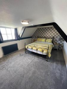 a bedroom with a bed in the corner of a room at The Little Angel in Whitby