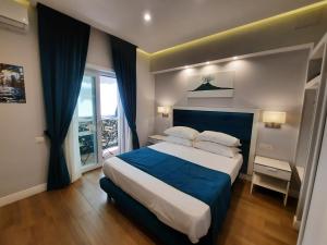 a bedroom with a large bed and a large window at Gea suite in Naples