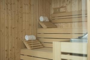 a room with wooden walls and shelves with towels at Luna Hotel Turismo in Abrantes