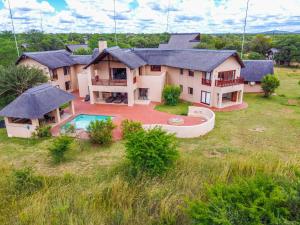 an aerial view of a house with a swimming pool at Waterberg House at Zebula - 8 adults and 4 kids in Mabula