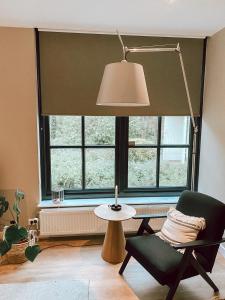 a room with a chair and a lamp and a window at Stay-Inn Harlingen in Harlingen