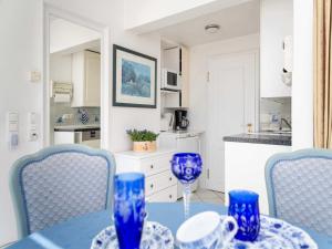 a blue table with blue chairs in a kitchen at Ferienwohnung Scheunemann in List