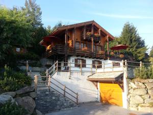 a large wooden house with stairs leading up to it at Chalet Lisa Ski-in, ski-out Well equipped in Nendaz +9 photos