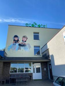 a sign on the side of a building at Ecohotel in Kretinga