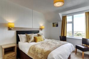 a bedroom with a large bed and a window at Palm Court in Skegness