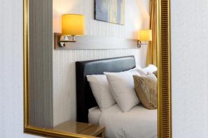a mirror in a room with a couch and pillows at Palm Court in Skegness
