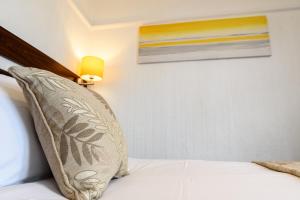 a bedroom with a bed with a pillow on it at Palm Court in Skegness