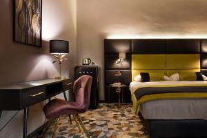 a bedroom with a bed and a desk and a chair at Mi Hotel Home in Rome