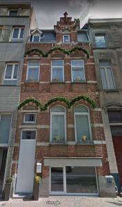 a tall brick building with windows and plants on it at Vakantie in Oostende Maison Martha -5 slaapkamers in Ostend