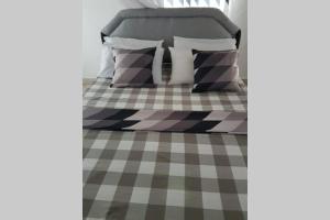 a bedroom with a bed with a checkered floor at Dadida‘s Pool Cottage in Diani Beach