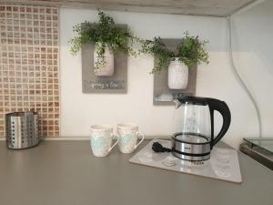 a kitchen counter with two cups and a tea kettle at Apartment Melani in Vir