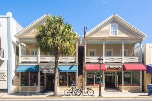 a palm tree in front of a building on a street at The Collins on Duval in Key West