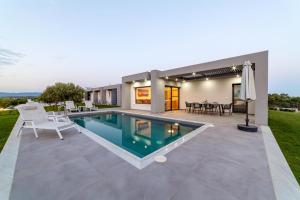 a swimming pool in the backyard of a house at Merelia Luxury Villas - Halkidiki in Nea Moudania