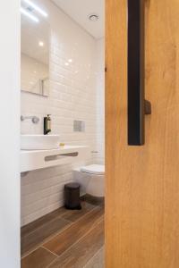 a bathroom with a toilet and a sink at Roots Hotel in Faro