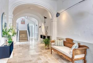 a living room with a couch and a staircase at Can Alberti 1740 Boutique Hotel in Mahón