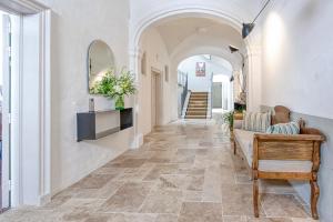 a hallway of a home with an archway and a couch at Can Alberti 1740 Boutique Hotel in Mahón