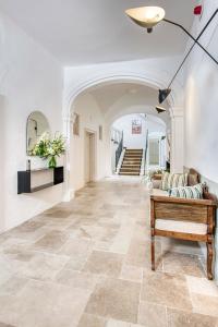 a hallway with a tile floor and a piano at Can Alberti 1740 Boutique Hotel in Mahón