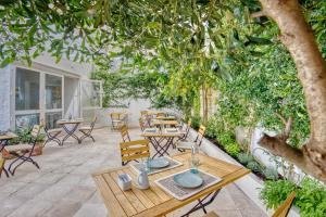 a patio area with tables, chairs, and tables at Can Alberti 1740 Boutique Hotel in Mahón