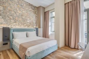 a bedroom with a bed and a window at Philia Boutique Hotel in Athens