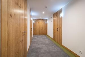 a hallway with wooden doors and a carpet at Roots Hotel in Faro