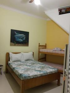 En eller flere senge i et værelse på Pousada Enseada de Bertioga
