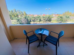 a table and chairs in a room with a window at Hotel San Teodoro in San Teodoro