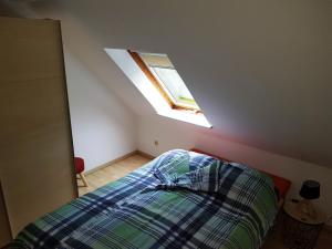 um quarto com uma cama e uma clarabóia em Iris 2-3 Personen - Ferienwohnungen Wagner & Gaul Falkenauel em Falkenauel