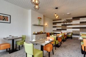 a dining room with tables and chairs in a restaurant at Palm Court in Skegness