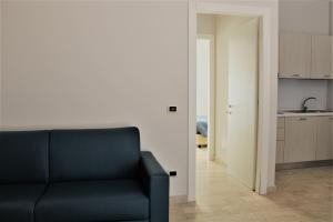 a living room with a couch and a kitchen at Zibibbo Beach Apartments - Trapani in Trapani