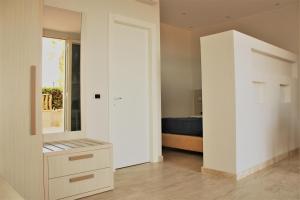 a bedroom with a large white closet and a bed at Zibibbo Beach Apartments - Trapani in Trapani
