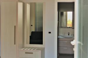 a bathroom with a sink and a mirror at Zibibbo Beach Apartments - Trapani in Trapani